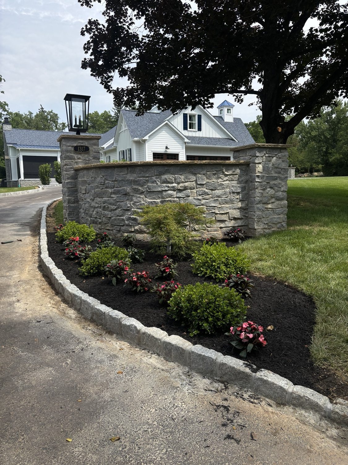 Custom Cobblestone Driveway Edging & Landscape Design project photo 1
